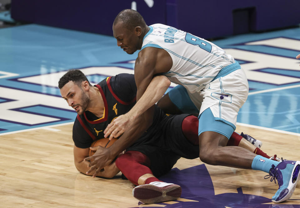 Charlotte Hornets center Bismack Biyombo, right, and Cleveland Cavaliers forward Larry Nance Jr. (22) vie for the ball during the second quarter of an NBA basketball game in Charlotte, N.C., Wednesday, April 14, 2021. (AP Photo/Nell Redmond)