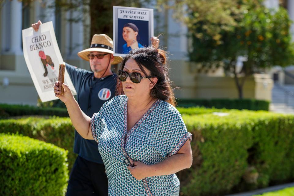 Lisa Matus marches to demand answers about the 13 jail deaths that have plagued the county this year, in downtown Riverside on Tuesday, Sept. 27, 2022.