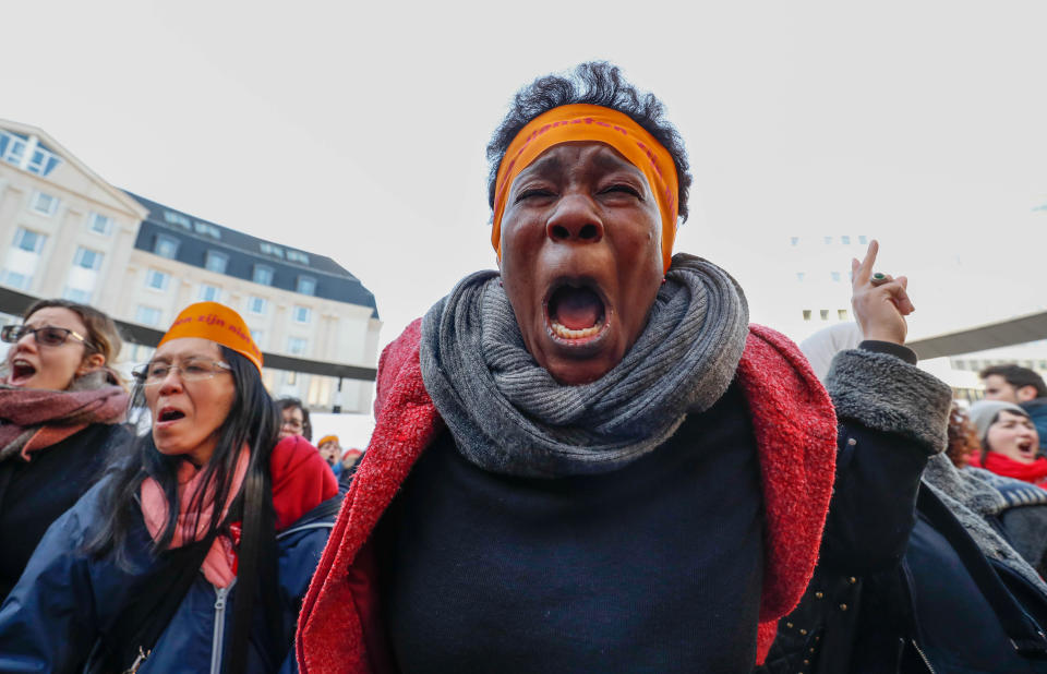 Women's rights activists shout during a street gathering.