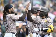 San Diego Padres' Luis Campusano, right, is congratulated by Fernando Tatis Jr. (23) after Campusano hit a three-run home run against the San Francisco Giants during the first inning of a baseball game Sunday, March 31, 2024, in San Diego. The Padres won 13-4. (AP Photo/Denis Poroy)