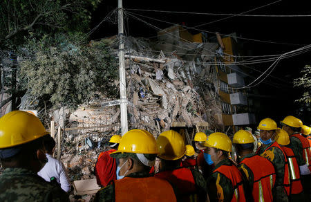 Rescuers work at the site of a collapsed building after an earthquake in Mexico City, Mexico September 20, 2017. REUTERS/Henry Romero