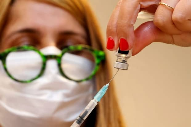 A medical worker prepares a shot of the Pfizer-BioNTech COVID-19 coronavirus vaccine at the outpatient clinic of the Cardiovascular Centre at Sheba Medical Center near Tel Aviv, Israel, on July 12. Nova Scotia reported two new cases of the virus on Wednesday. (Jack Guez/AFP/Getty Images - image credit)