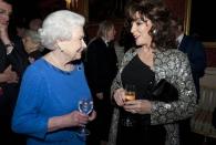 <p>Joan Collins isn’t the muted outfit type—and the silver metallic jacket she wore to meet the Queen is proof. She *almost* upstaged the Queen, but everyone knows that’s impossible, so, moving on!</p>