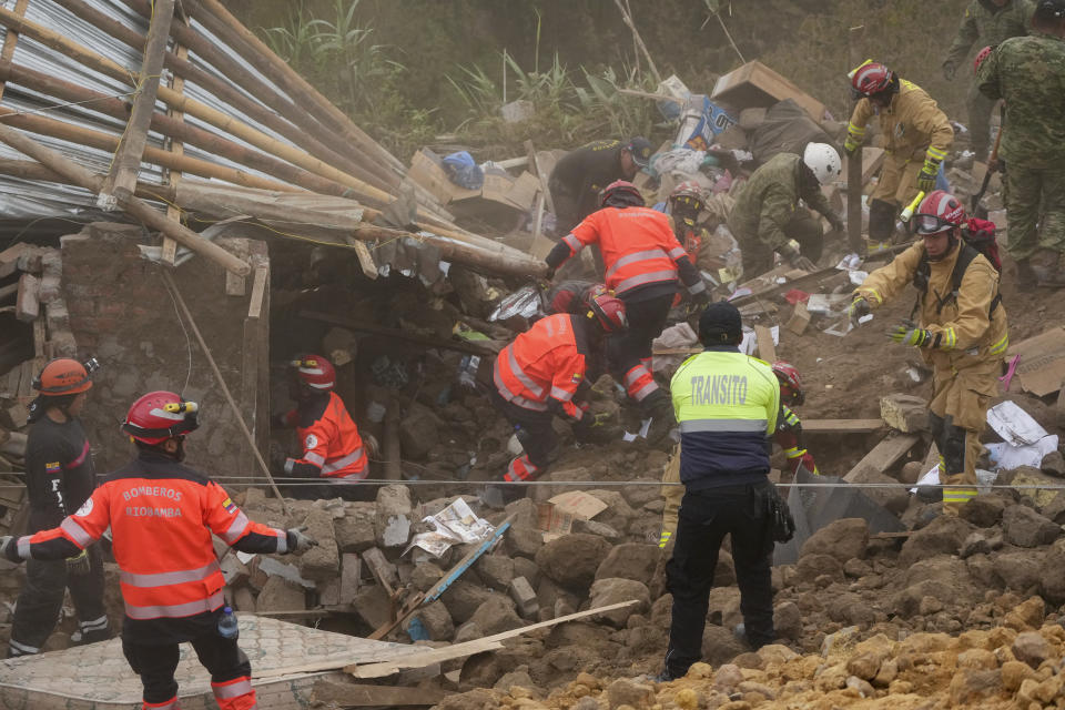 Rescue workers inspect a home destroyed by a deadly landslide that buried dozens of homes in Alausi, Ecuador, Monday, March 27, 2023. (AP Photo/Dolores Ochoa)