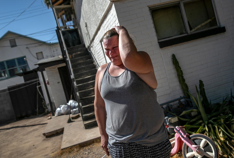 A mother is overcome with emotion after being served a court eviction order for non-payment of rent on September 30, 2020 in Phoenix, Arizona. (Photo by John Moore/Getty Images)