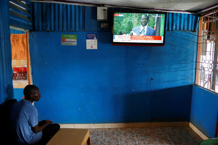 A man sitting in a bar watches Kenyan opposition leader of the National Super Alliance (NASA) coalition Raila Odinga's news conference in Kisumu, Kenya October 31, 2017. REUTERS/Baz Ratner