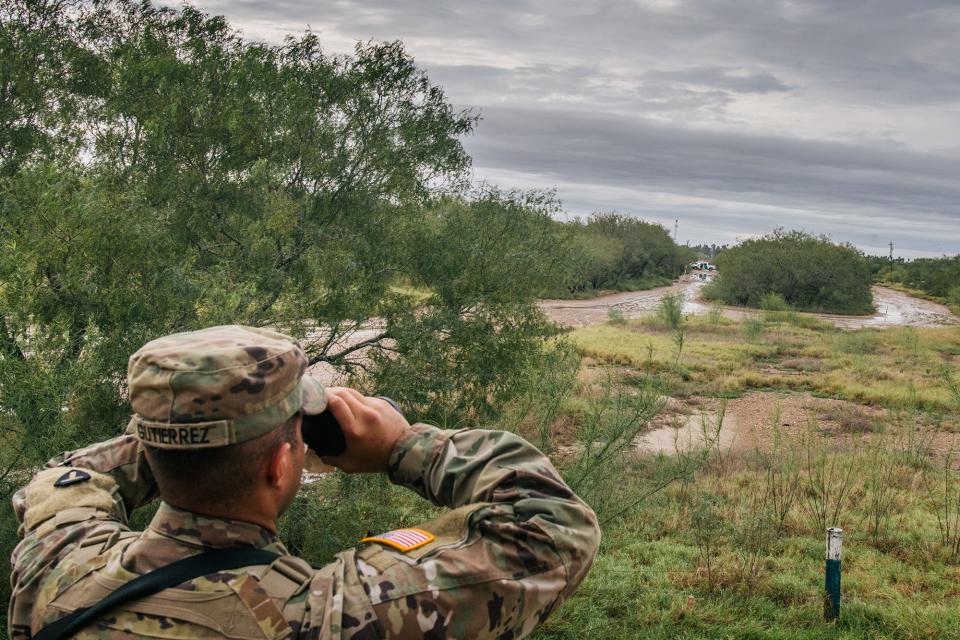 A U.S. National Guard member keeps watch while on a border patrol operation on Nov. 18, 2021, in La Joya, Texas. Guard members deployed to Operation Lone Star along the border have complained of shoddy housing, lack of equipment and erratic pay.