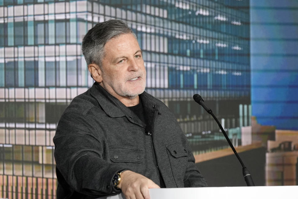 Bedrock Chairman Dan Gilbert addresses a news conference, Monday, April 15, 2024 in Detroit. General Motors plans to move its iconic Detroit headquarters to a new downtown office tower and redevelop its home office site. In addition, Bedrock, which owns multiple office buildings downtown, will join GM in studying redevelopment of the seven-building Renaissance Center now owned by GM. The new building is on the site of the old Hudson's department store in the heart of downtown. (AP Photo/Carlos Osorio)