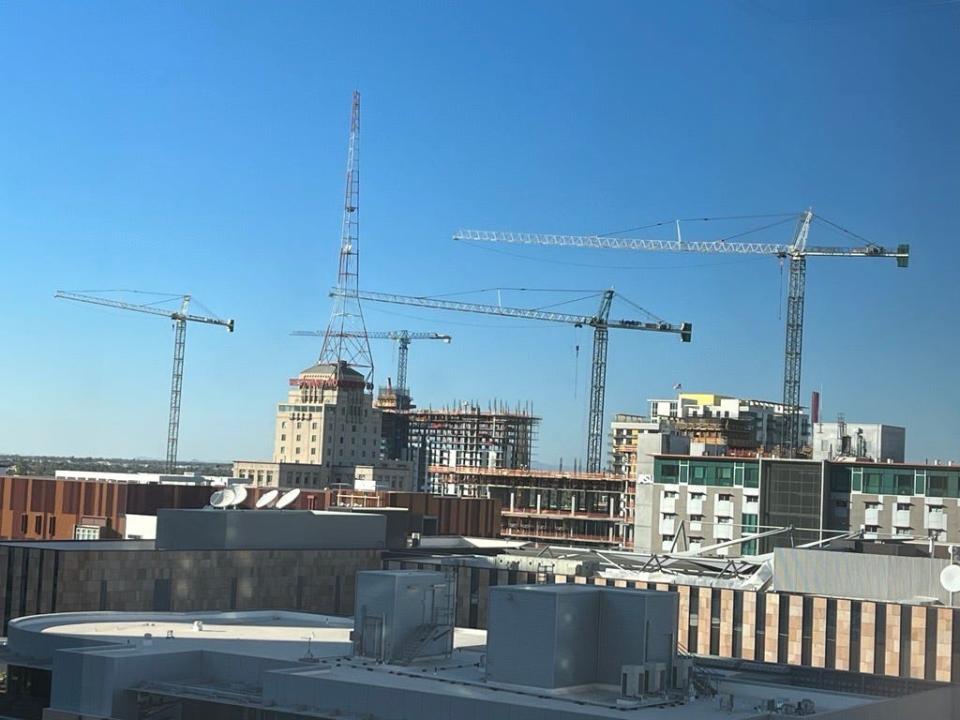 Four tower cranes are in use at high-rise development projects in downtown Phoenix in November 2023.
