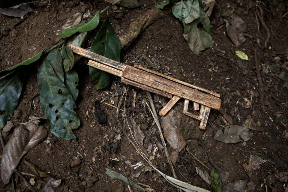 A toy machine gun sits in the mud in the village of Siwa, Central African Republic, Saturday Feb. 13, 2021. An estimated 240,000 people have been displaced in the country since mid-December, according to U.N. relief workers, when rebels calling themselves the Coalition of Patriots for Change launched attacks, causing a humanitarian crisis in the already unstable nation. (AP Photo/Adrienne Surprenant)