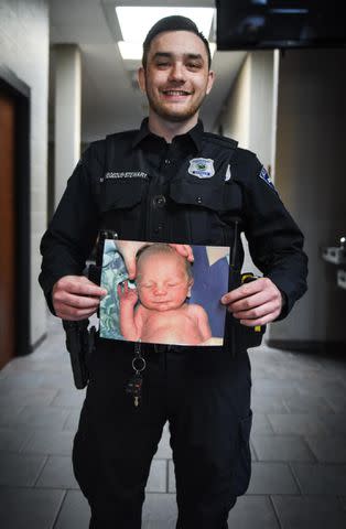 <p>Ashley O'Chap/South Bend Police Department </p> Matthew Hegedus-Stewart holding his baby picture.