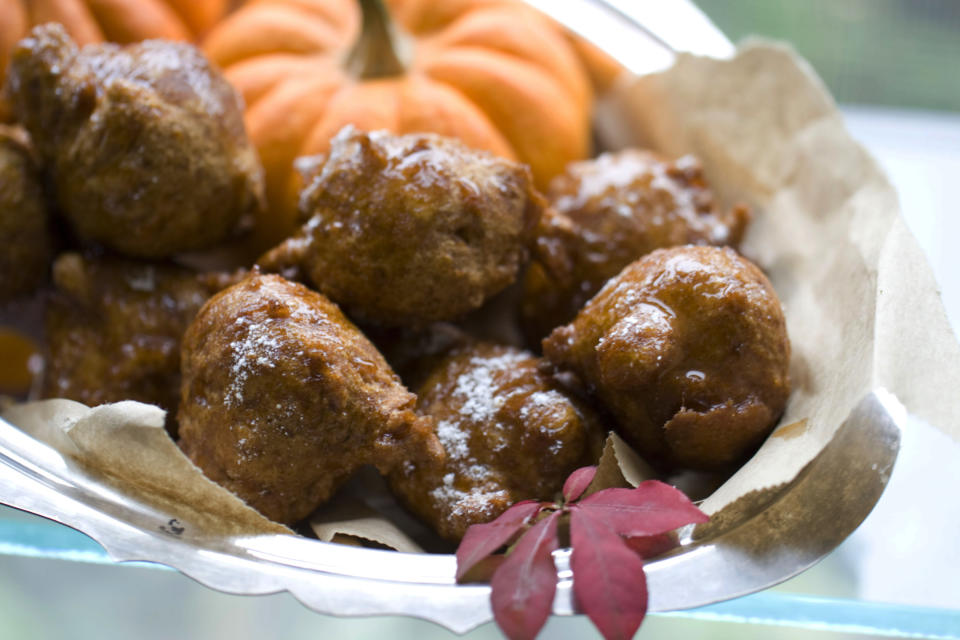 This Oct. 7, 2013 photo shows pumpkin honey doughnuts in Concord, N.H. To help bridge the holidays of Hanukkah and Thanksgiving, this recipe combines the classic fried doughnut from Hanukkah and pumpkin pie from Thanksgiving, into one delicious treat. (AP Photo/Matthew Mead)