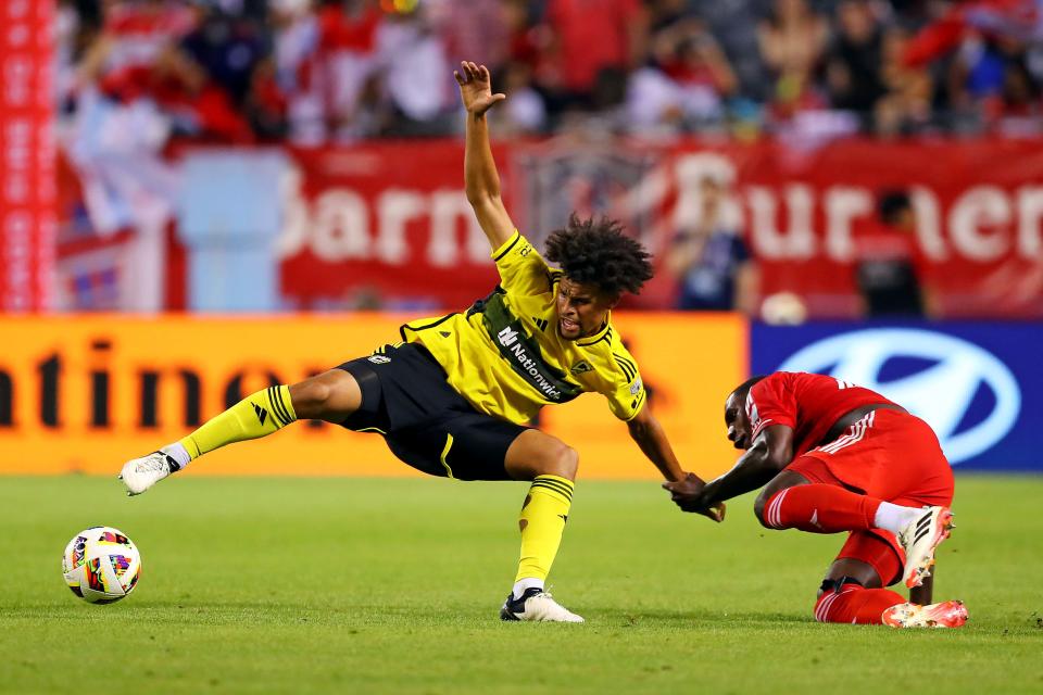 Crew forward Jacen Russell-Rowe is pulled by Chicago defender Carlos Teran on Saturday.