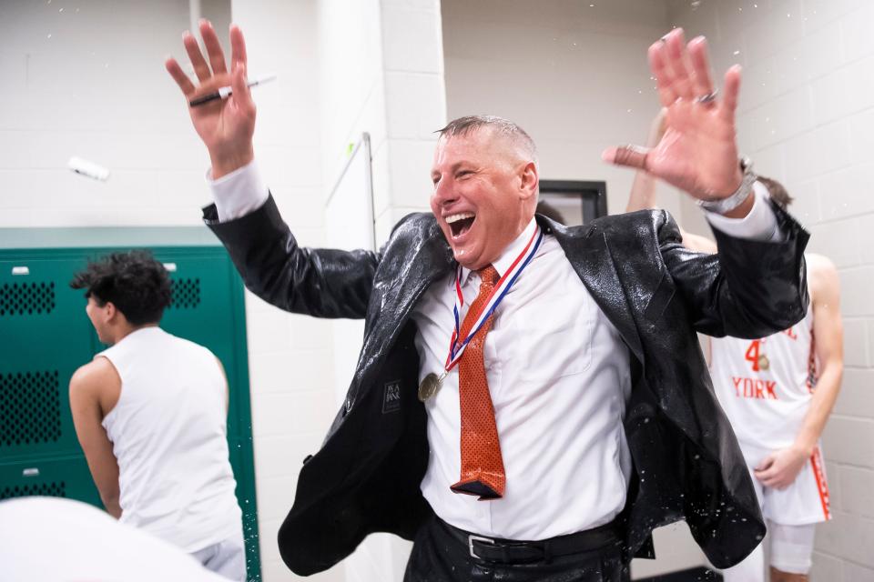 Central York head coach Jeff Hoke reacts after getting a full-body water bottle bath from his players as they celebrate in the locker room following their YAIAA boys' basketball championship win against York High at the York Tech Field House Feb. 16, 2023, in York Township. The Panthers won, 85-71.