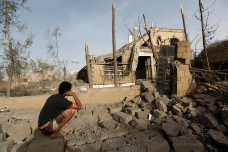 A man sits in front of a house destroyed by air strikes in Sanaa, Yemen June 6, 2018. REUTERS/Khaled Abdullah