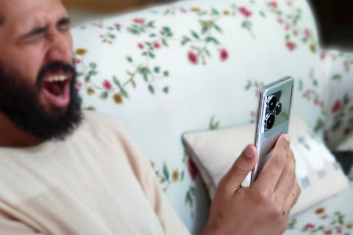 Man yawning while using the Realme GT 6.