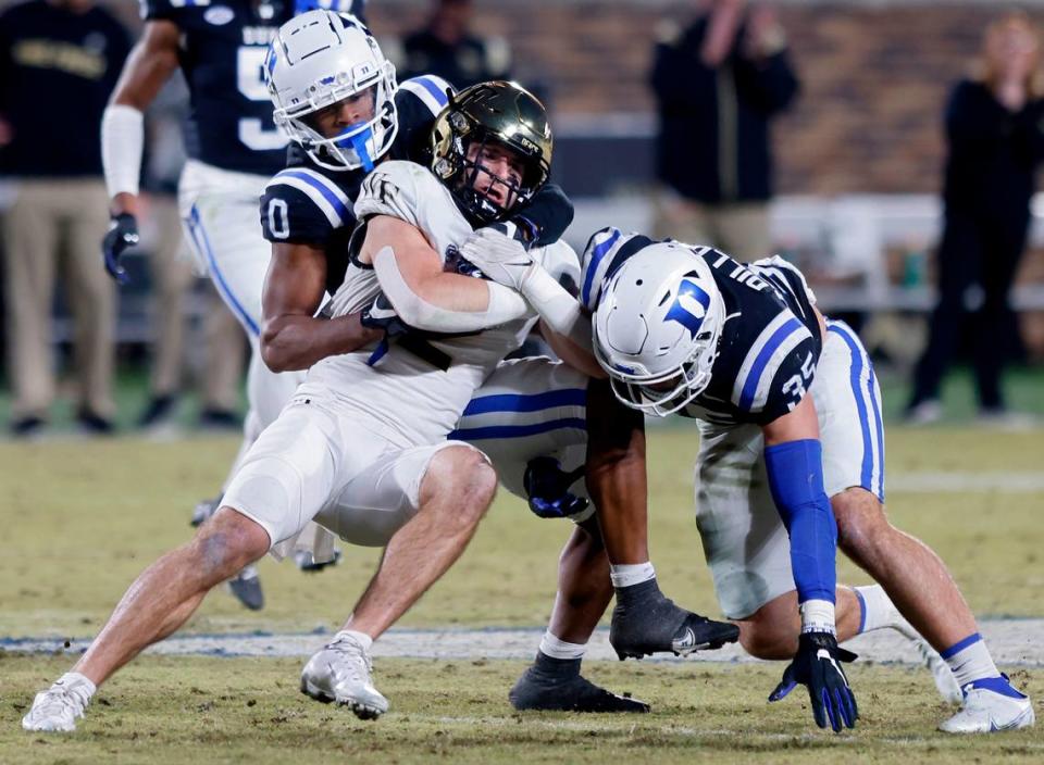 Duke’s Chandler Rivers and Cam Dillon tackle Wake Forest’s Taylor Morin during the second half of the Blue Devils’ final regular season game at Wallace Wade Stadium on Saturday, Nov. 26, 2022, in Durham, N.C.