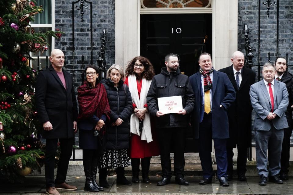 Dame Diana Johnson (fourth from left), Jason Evans (fifth from left), Damian Green (sixth from left) and other campaigners in Downing Street with a letter calling for faster compensation for victims of the infected blood scandal (PA)