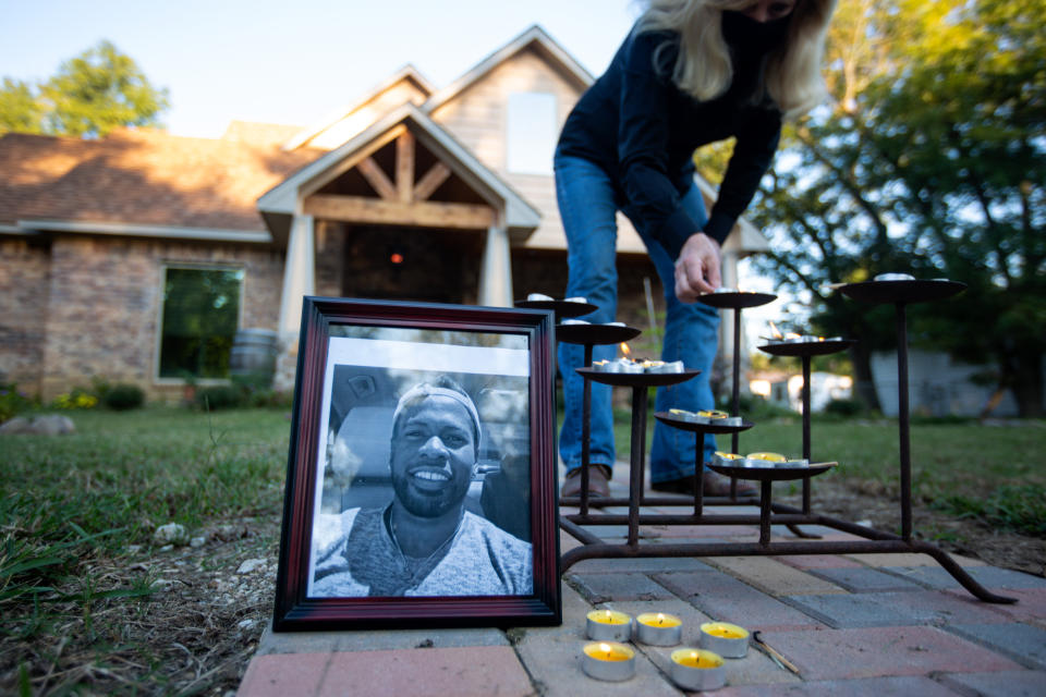 Picture of Jonathan Price with candles in front of a residence in Wolfe City, Texas. (Photo by Montinique Monroe/Getty Images)