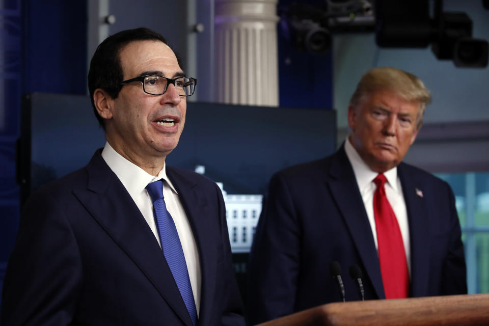 President Donald Trump listens as Treasury Secretary Steven Mnuchin speaks about the coronavirus in the James Brady Press Briefing Room at the White House, Monday, April 13, 2020, in Washington. (AP Photo/Alex Brandon)