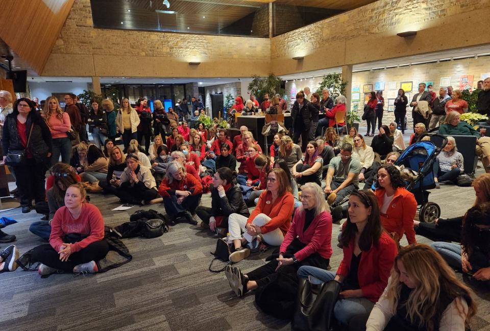 Members of the audience spilled out into the lobby of the Upper Arlington city building on Tremont Road to watch Tuesday's Upper Arlington Board of Education meeting. Due to the large crowd, those in the lobby watched on livestream televisions.