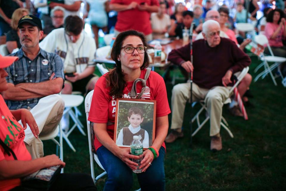 Francine Wheeler displays a photograph of her son, Sandy Hook Elementary shooting victim Ben Wheeler, at a 2018 gun control rally. <a href="https://www.gettyimages.com/detail/news-photo/francine-wheeler-displays-a-photograph-of-her-son-sandy-news-photo/1015738992" rel="nofollow noopener" target="_blank" data-ylk="slk:Kena Betancur/AFP via Getty Images;elm:context_link;itc:0;sec:content-canvas" class="link ">Kena Betancur/AFP via Getty Images</a>