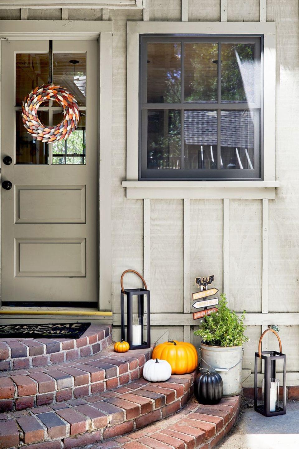 <p>Opt for a wreath that you can leave up all season long, like the one shown here (it's made of paper!). <a href="https://stylebyemilyhenderson.com/blog/target-fall-halloween-decorating-ideas" rel="nofollow noopener" target="_blank" data-ylk="slk:This one;elm:context_link;itc:0;sec:content-canvas" class="link ">This one</a> is great for both Halloween and Thanksgiving, thanks to the faux paper leaves in a fall color palette.</p>