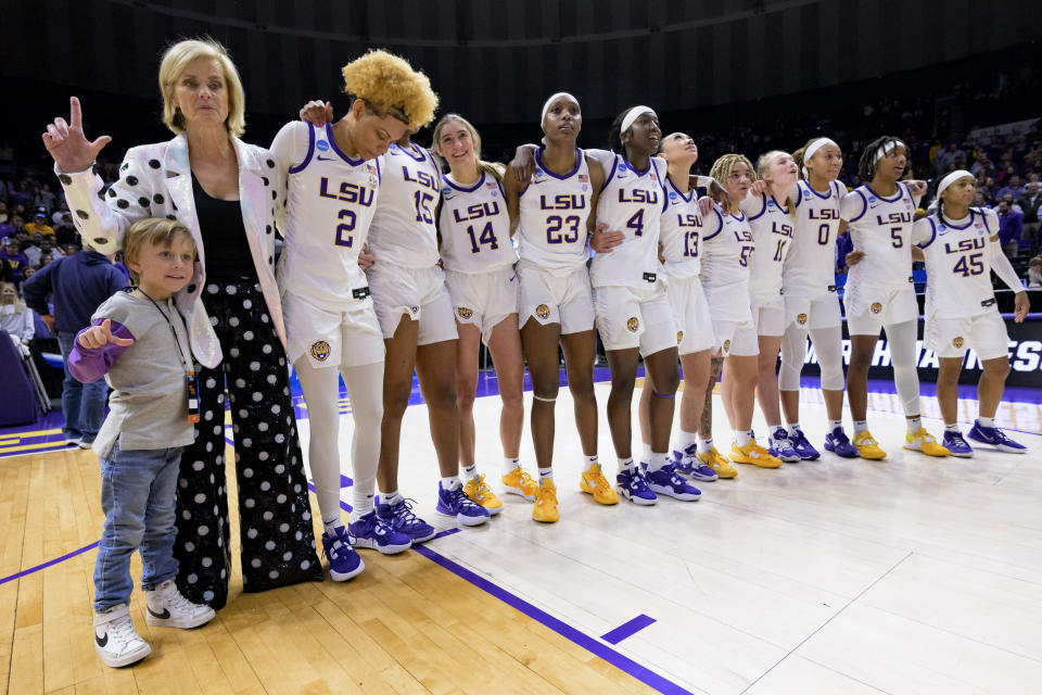 LSU coach Kim Mulkey, left, joins players for the school's alma mater after LSU defeated Michigan in a second-round college basketball game in the women's NCAA Tournament in Baton Rouge, La., Sunday, March 19, 2023. (AP Photo/Matthew Hinton)