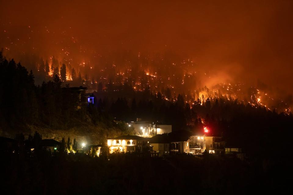 Homes are pictured near the McDougall Creek Wildfire as it burns in West Kelowna, British Columbia on Friday, August 18, 2023. 