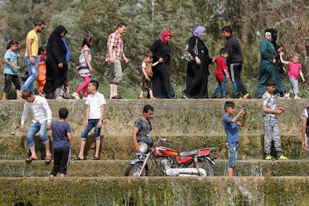 Iraqi families and youths enjoy their Friday holiday at Shallalat district (Arabic for "waterfalls") in eastern Mosul, Iraq, April 21, 2017. REUTERS/ Muhammad Hamed