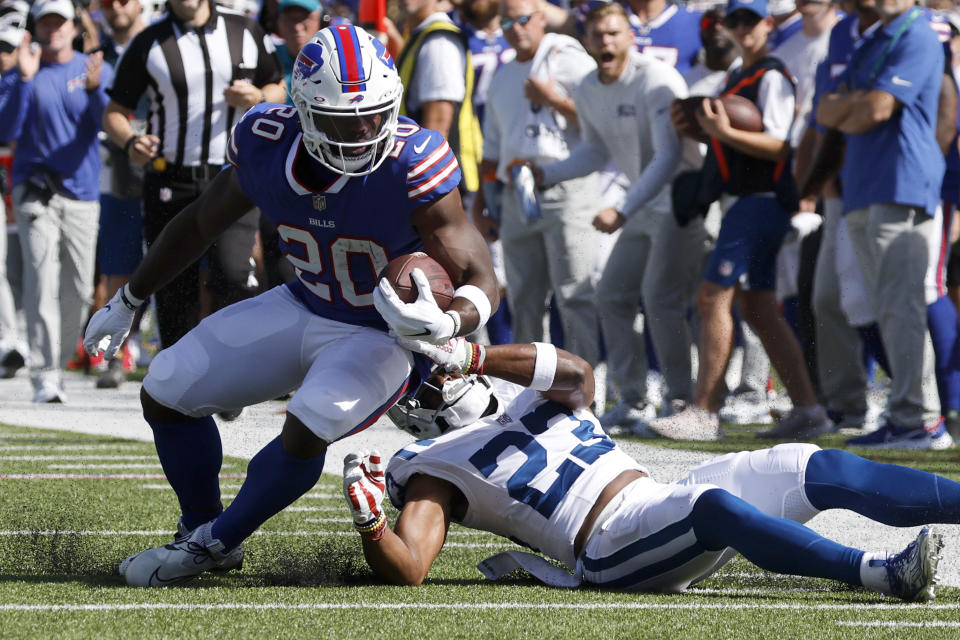 Buffalo Bills running back Zack Moss (20) runs with the ball as Indianapolis Colts cornerback Kenny Moore II (23) tries to get a grip on him during the first half of a preseason NFL football game, Saturday, Aug. 13, 2022, in Orchard Park, N.Y. (AP Photo/Jeffrey T. Barnes)