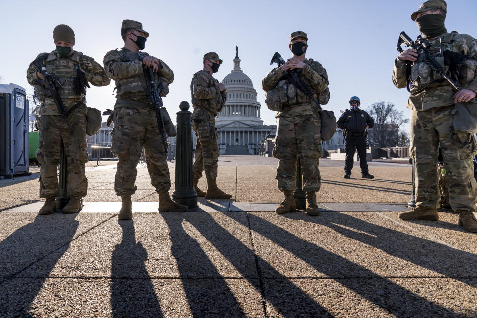 Members of the Michigan National Guard and the U.S. Capitol Police keep watch as heightened security remains in effect around the Capitol grounds since the Jan. 6 attacks by a mob of supporters of then-President Donald Trump, in Washington, Wednesday, March 3, 2021. The U.S. Capitol Police say they have intelligence showing there is a "possible plot" by a militia group to breach the Capitol on Thursday. (AP Photo/J. Scott Applewhite)