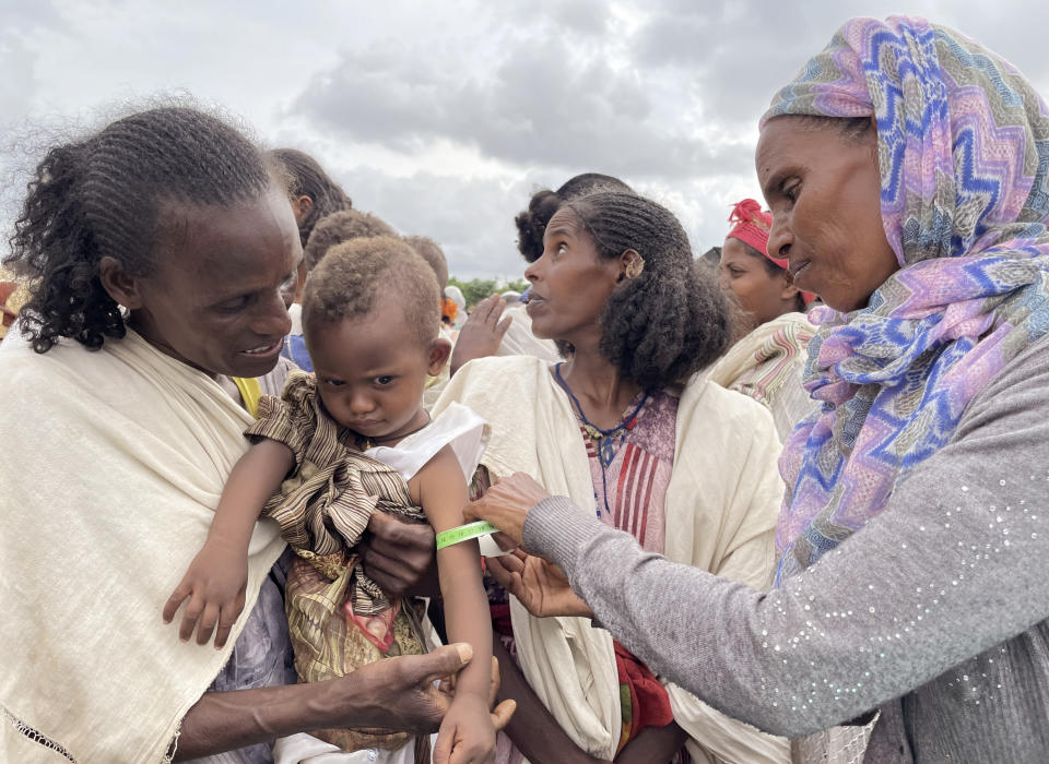 A young child is screened for malnutrition by World Food Programme (WFP) workers in the Adi Daero district of the Tigray region of northern Ethiopia Saturday, Aug. 21, 2021. (Claire Nevill/WFP via AP)