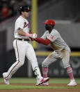 Philadelphia Phillies' Didi Gregorius, right, tags out Atlanta Braves' Austin Riley in a rundown between second and third during the eighth inning of a baseball game Sunday, May 9, 2021, in Atlanta. (AP Photo/Ben Margot)