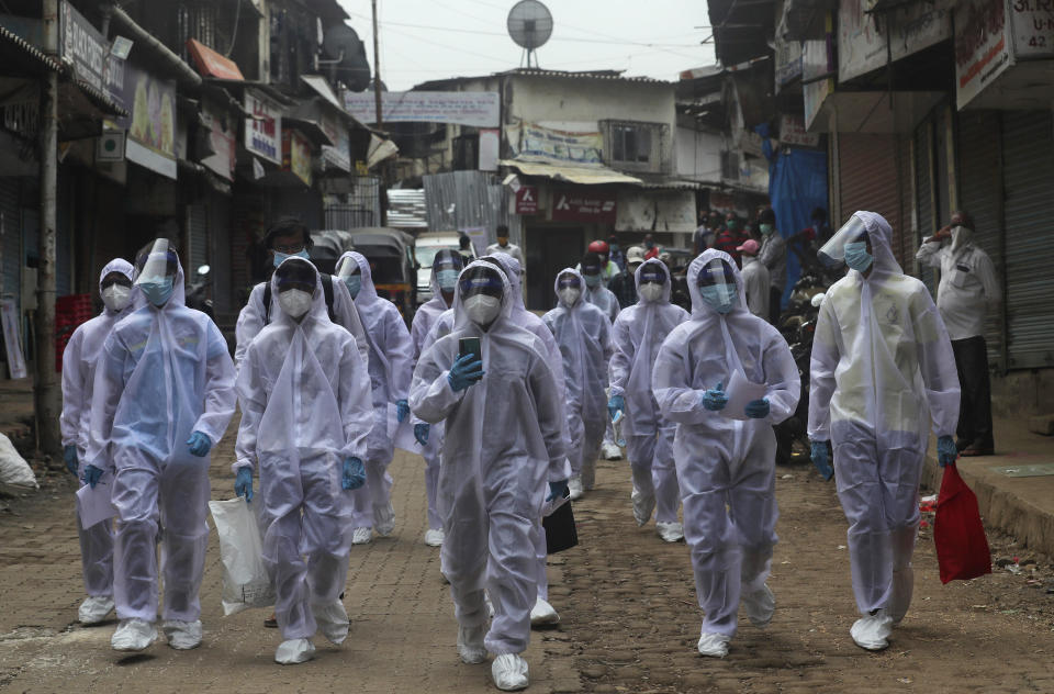 Health workers arrive to administer a medical camp in a slum in Mumbai, India, Sunday, June 28, 2020. India is the fourth hardest-hit country by the COVID-19 pandemic in the world after the U.S., Russia and Brazil. (AP Photo/Rafiq Maqbool)
