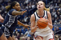 UConn's Dorka Juhasz, right, looks to shoot as Georgetown's Ariel Jenkins, left, defends in the first half of an NCAA college basketball game, Sunday, Jan. 15, 2023, in Hartford, Conn. (AP Photo/Jessica Hill)