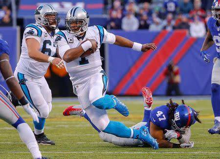 Dec 20, 2015; East Rutherford, NJ, USA; Carolina Panthers quarterback Cam Newton (1) runs after breaking tackle by New York Giants middle linebacker Uani' Unga (47) during the fourth quarter at MetLife Stadium. Mandatory Credit: Jim O'Connor-USA TODAY Sports