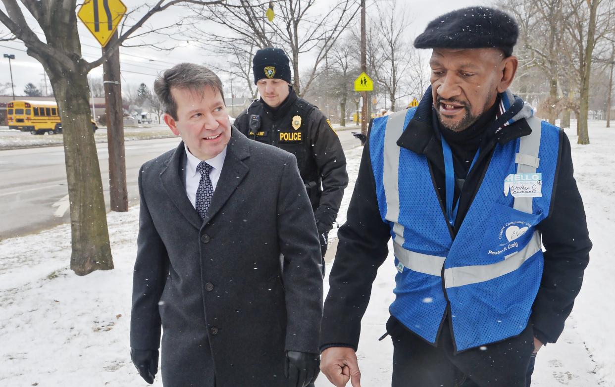 Walking from United Way offices at the former Wayne Middle School to Edison Elementary, Erie School District Superintendent Brian Polito, left, joins Blue Coats founder Daryl Craig highlighting safe walking routes for students in Erie on Jan. 31, 2023.