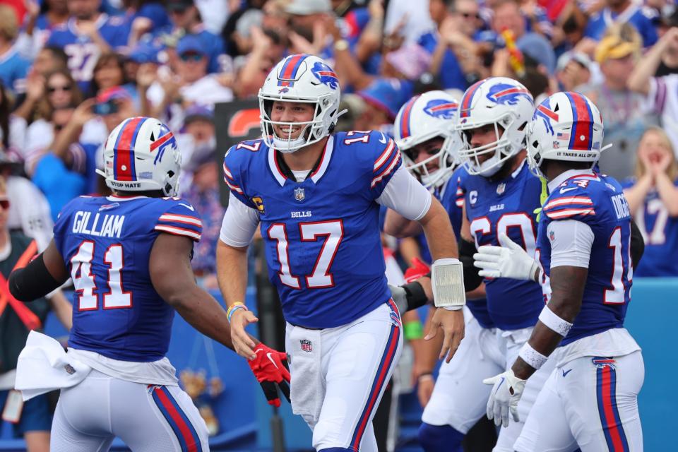 Buffalo Bills quarterback Josh Allen (17) celebrates with teammates after throwing a touchdown pass to Dawson Knox during the first half of an NFL football game, Sunday, Sept. 17, 2023, in Orchard Park, N.Y. (AP Photo/Jeffrey T. Barnes)