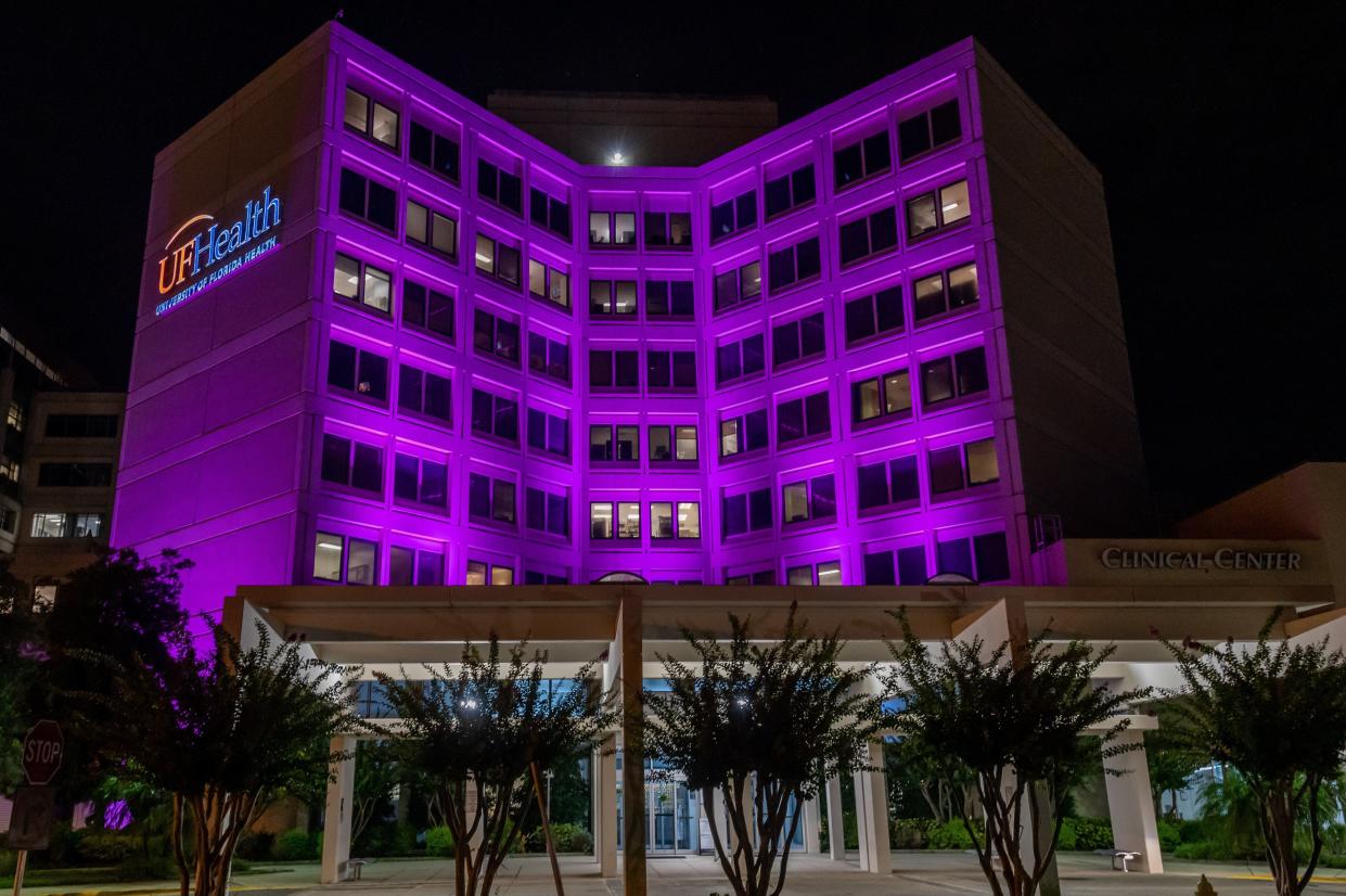 The front of the Clinical Center at the downtown campus of UF Health Jacksonville is illuminated in purple lights in August 2021 in memory of CEO Leon Haley Jr., who died in a Jet Ski accident at the age 56.