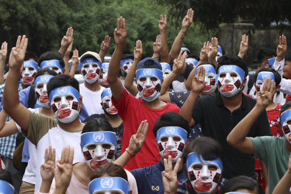 Young demonstrators flash the three-fingered symbol of resistance during an anti-coup mask strike in Yangon, Myanmar, Sunday, April 4, 2021. Threats of lethal violence and arrests of protesters have failed to suppress daily demonstrations across Myanmar demanding the military step down and reinstate the democratically elected government. (AP Photo)