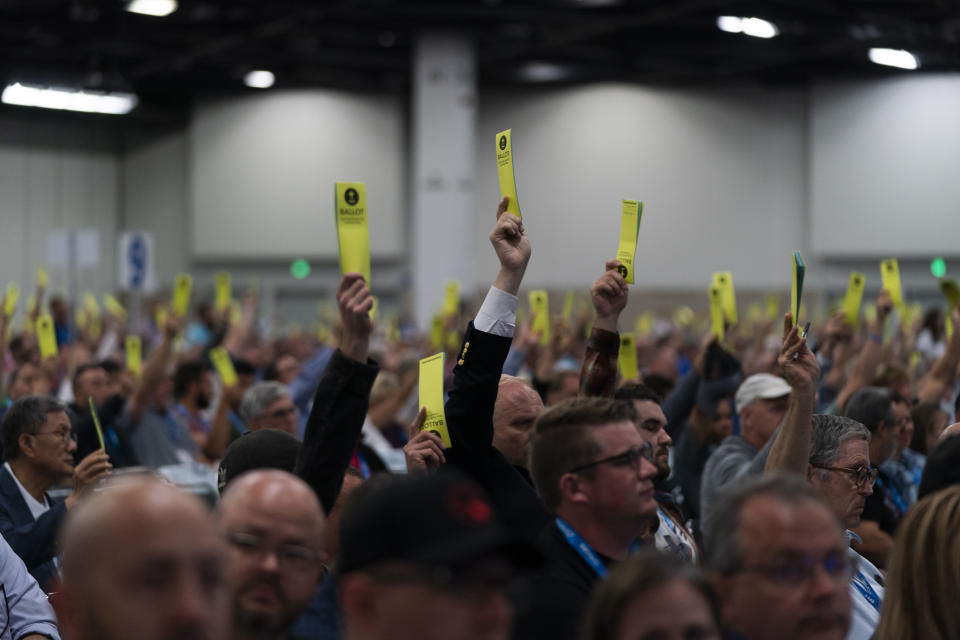 Attendees hold up their ballots during a session at the Southern Baptist Convention's annual meeting in Anaheim, Calif., Tuesday, June 14, 2022. (AP Photo/Jae C. Hong)