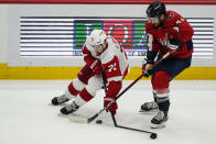 Detroit Red Wings center Dylan Larkin (71) breaks his stick with Washington Capitals right wing Tom Wilson (43) nearby in the third period of an NHL hockey game, Wednesday, Oct. 27, 2021, in Washington. The Red Wings won 3-2 in overtime. (AP Photo/Alex Brandon)