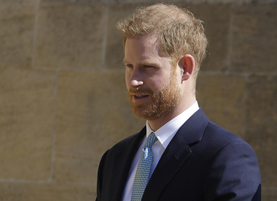 FILE - In this Sunday, April 21, 2019 file photo, Britain's Prince Harry arrives to attend the Easter Mattins Service at St. George's Chapel, at Windsor Castle in England. Prince Harry is offering his support to Angola’s new 47 million pound ($60 million) initiative to clear land-mines, saying it will protect lives and help communities through conservation-led development. Speaking Monday at the Chatham House think tank, Harry picked up the mantle for a cause near to the heart of his mother, the late Princess Diana, who worked with the Halo Trust on de-mining issues. (AP Photo/Kirsty Wigglesworth, file)