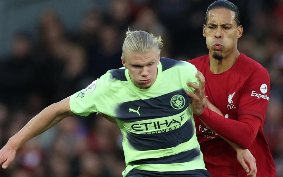 Manchester City's Erling Haaland in action with Liverpool's Virgil van Dijk