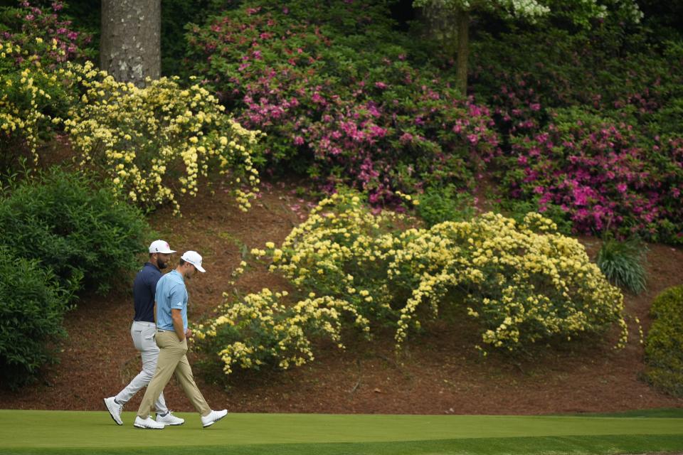 Jon Rahm, of Spain, and Nicolai Hojgaard, of Denmark, walk onto the 12th green during a practice round in preparation for the Masters golf tournament at Augusta National Golf Club Tuesday, April 9, 2024, in Augusta, Ga. (AP Photo/Matt Slocum)