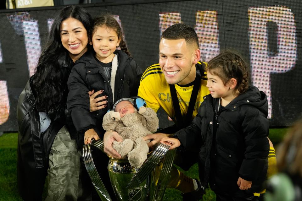 The Ramirez family – mom Valerie, oldest daughter Zara, father Christian, daughter Nova and son Kash – pose with the MLS Cup trophy following the Crew's MLS Cup victory. Kash is in the trophy.