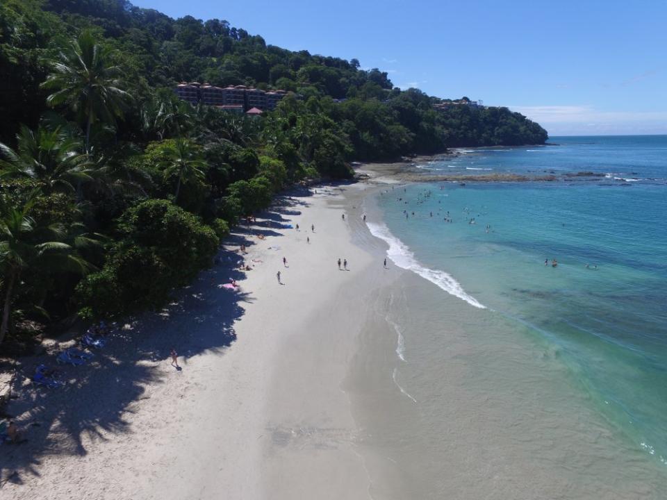 people walking on Punta Leona Beach