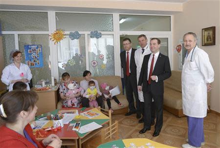 Russia's Prime Minister Dmitry Medvedev (2nd R, front) visits a children's hospital in the Crimean city of Simferopol, March 31, 2014. REUTERS/RIA Novosti/Alexander Astafyev/Pool