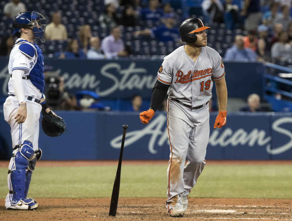 Baltimore Orioles' Chris Davis hits a solo home run as Toronto Blue Jays catcher Danny Jansen watches during the 12th inning of a baseball game, Monday, Sept. 23, 2019, in Toronto. (Fred Thornhill/The Canadian Press via AP)